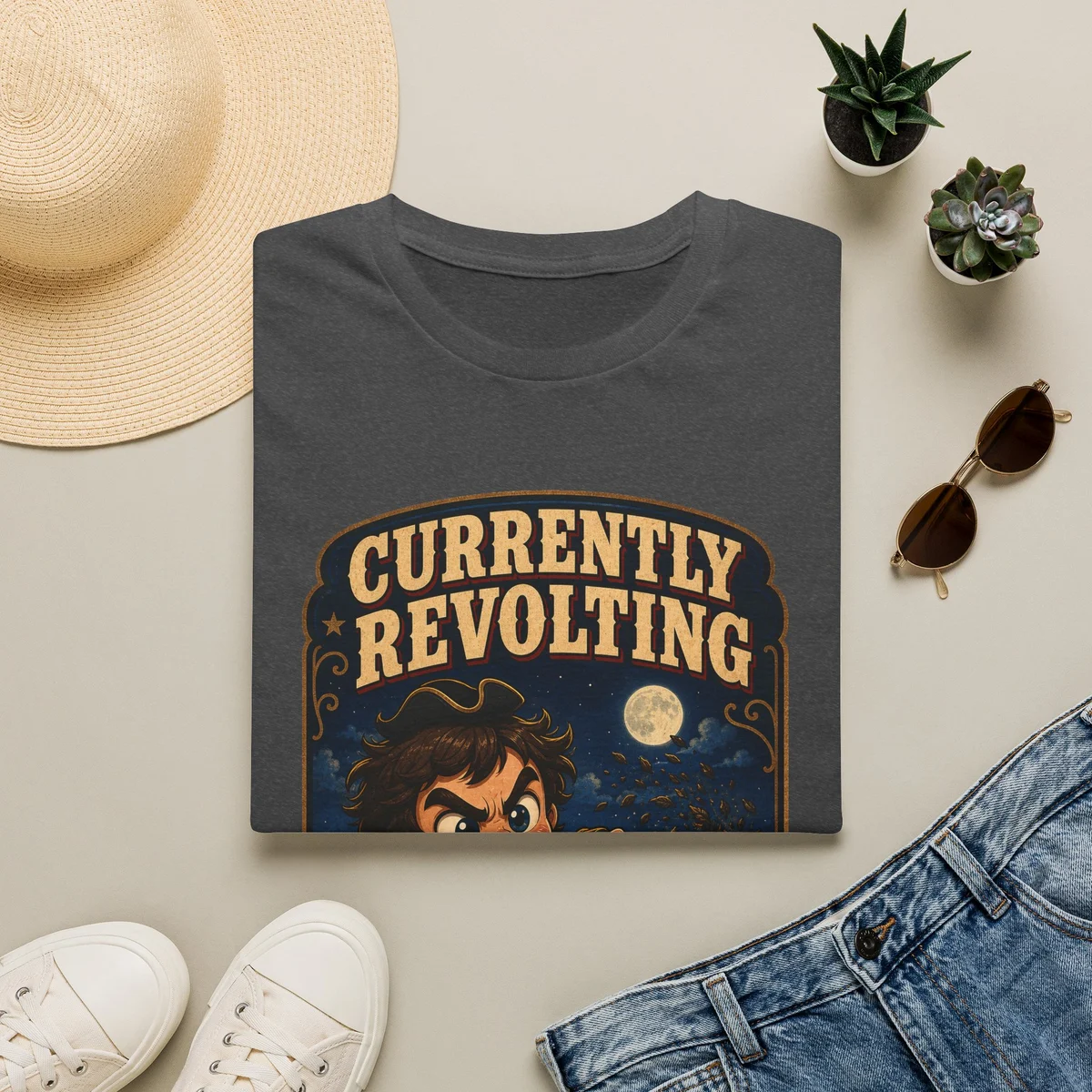 Currently Revolting artwork printed on a folded Dark Heather Gildan Softstyle T-shirt
